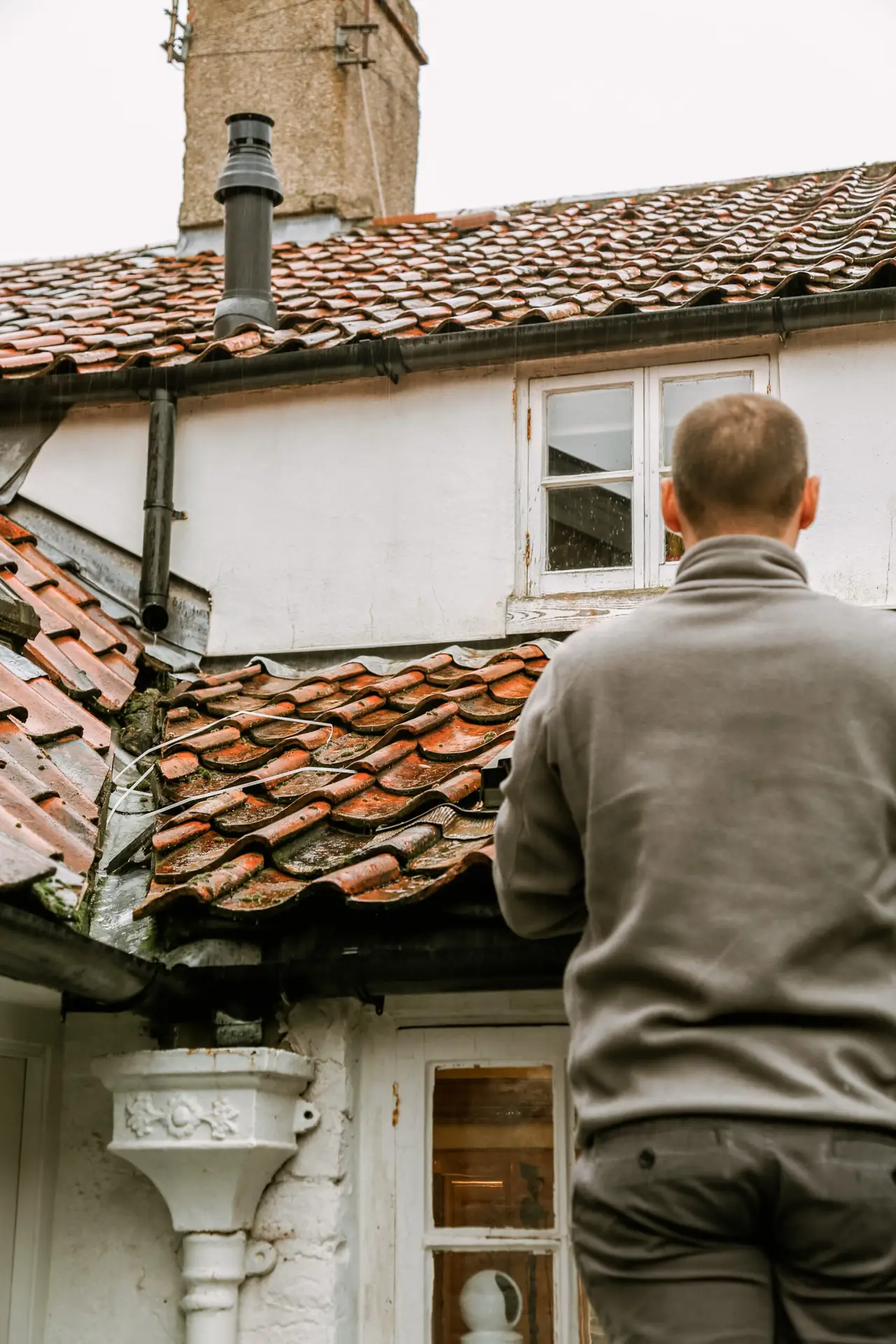 A surveyor inspecting the roof of a period property