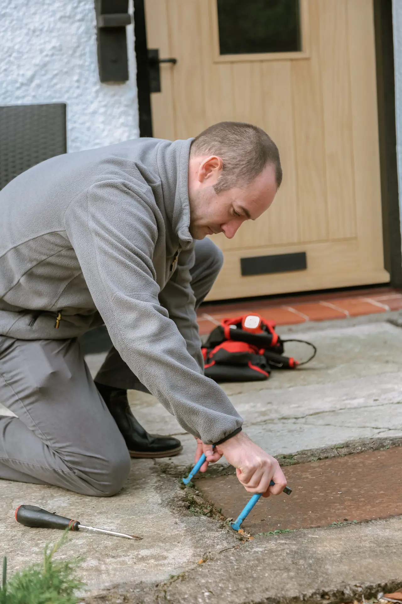 A surveyor using a damp meter